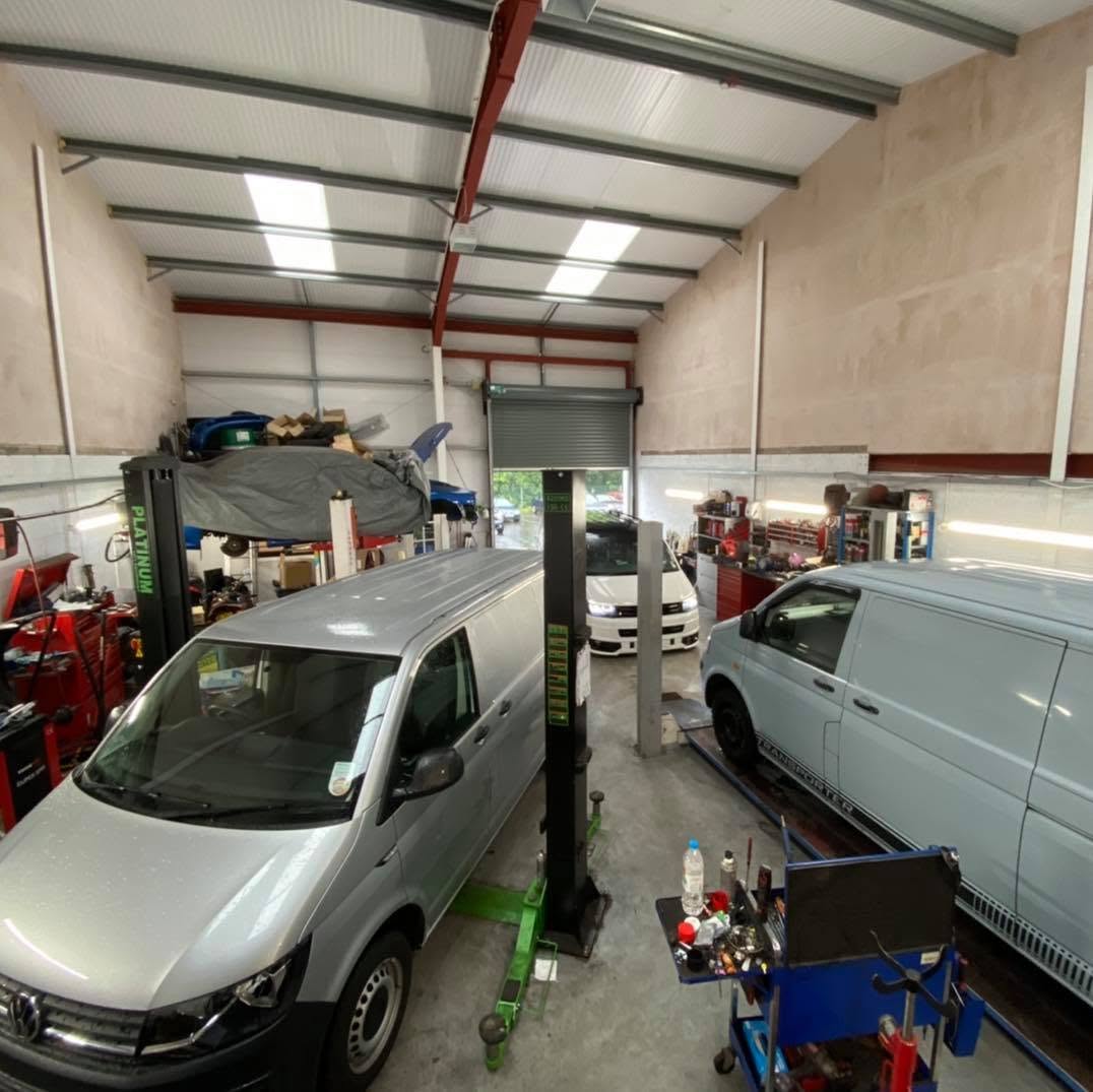 Vans up on the two-post lifts inside the Bailey's Garage workshop