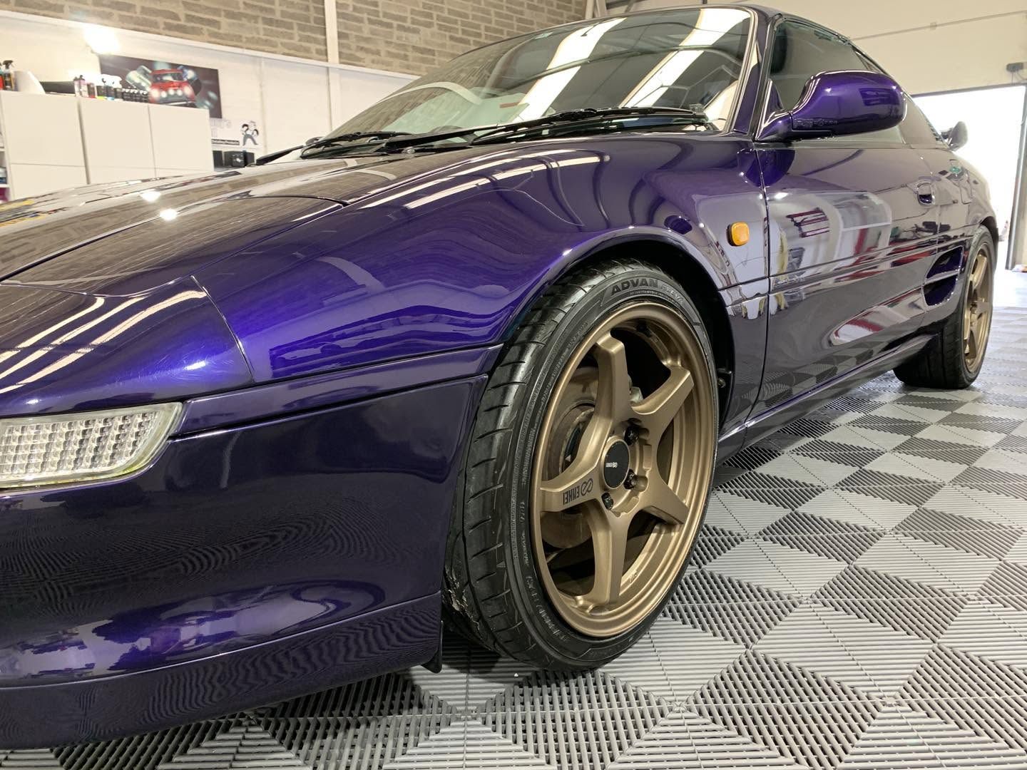 Deep purple Porsche 911 on bronze wheels, freshly detailed