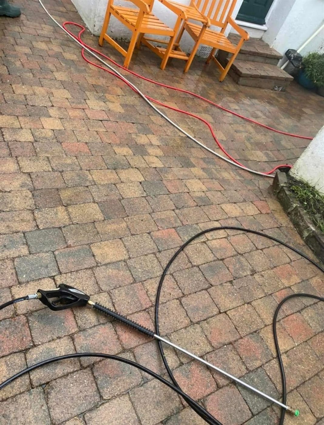 Jet washing lance and hoses on freshly cleaned block paving