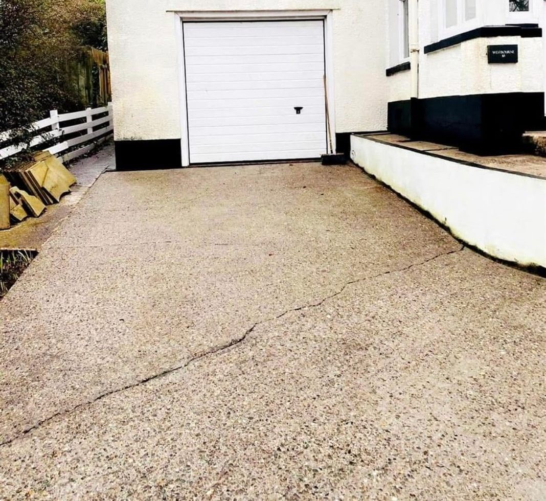 Driveway after jet washing, clean concrete from the garage to the gate