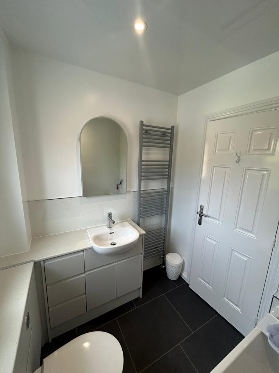 Bathroom vanity with arched mirror