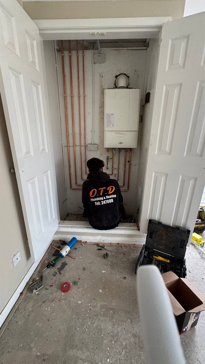 OTD engineer fitting a boiler with new copper pipework