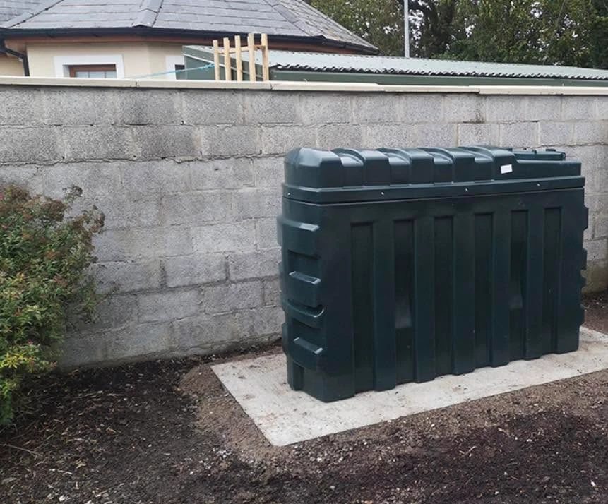 New green oil tank on a fresh concrete base